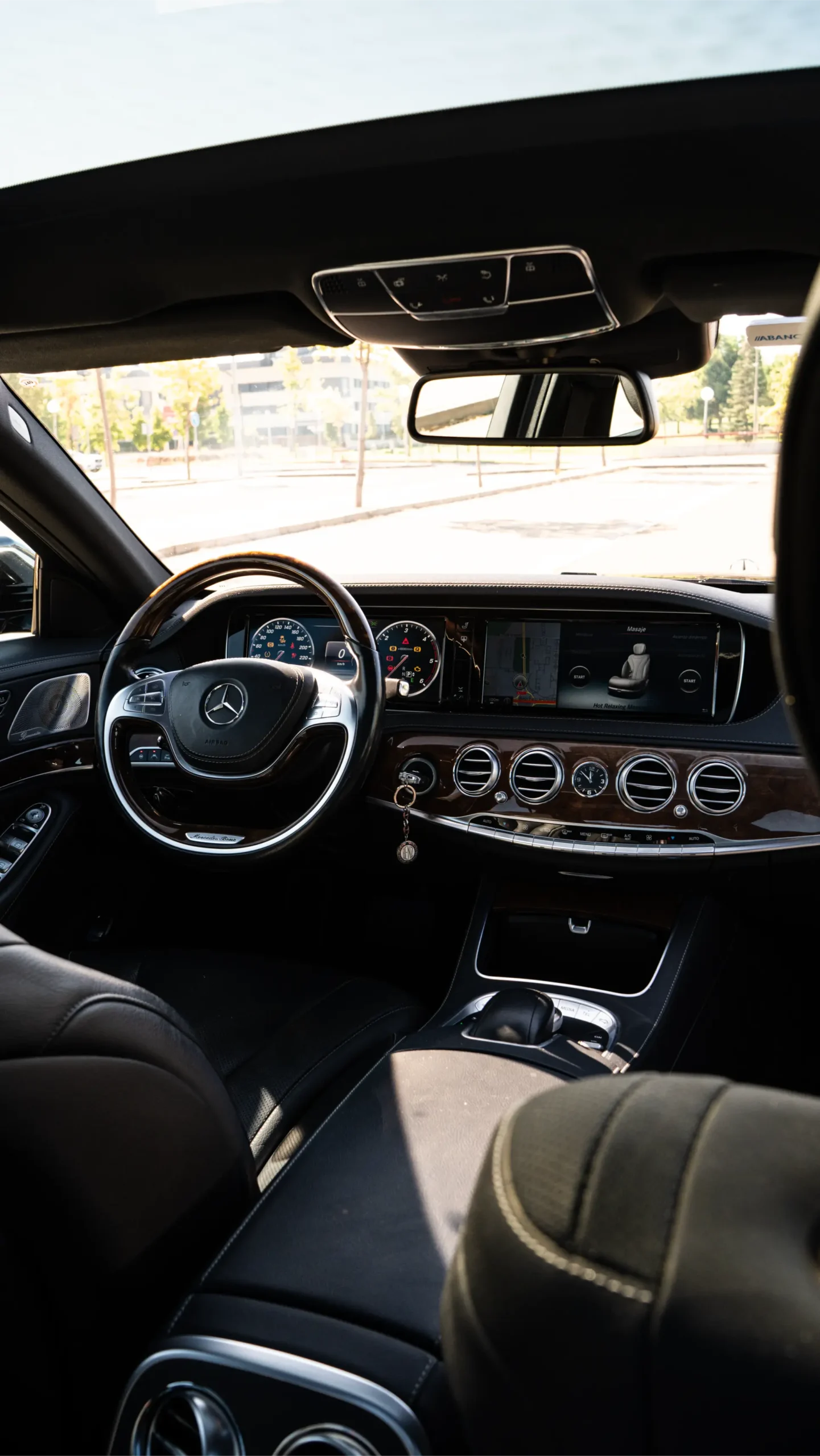 Interior view of a Mercedes-Benz S-Class from the rear passenger seat, highlighting luxury and comfort for corporate and business travel - RiojaBlack.