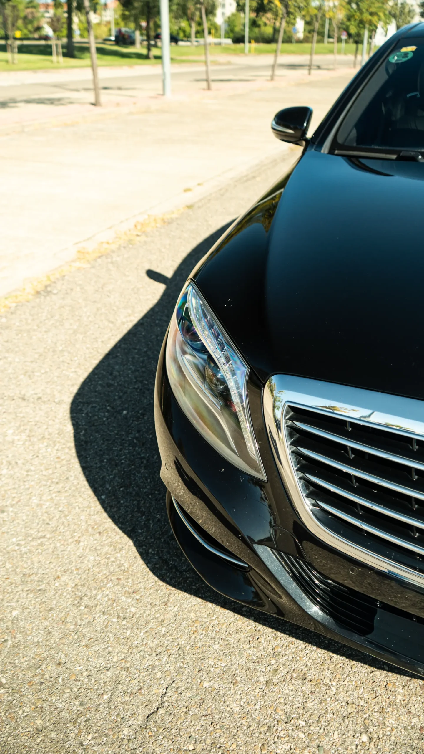 Overhead view of a black Mercedes-Benz S-Class hood, representing luxury transport for bespoke culinary and wine tours by RiojaBlack.