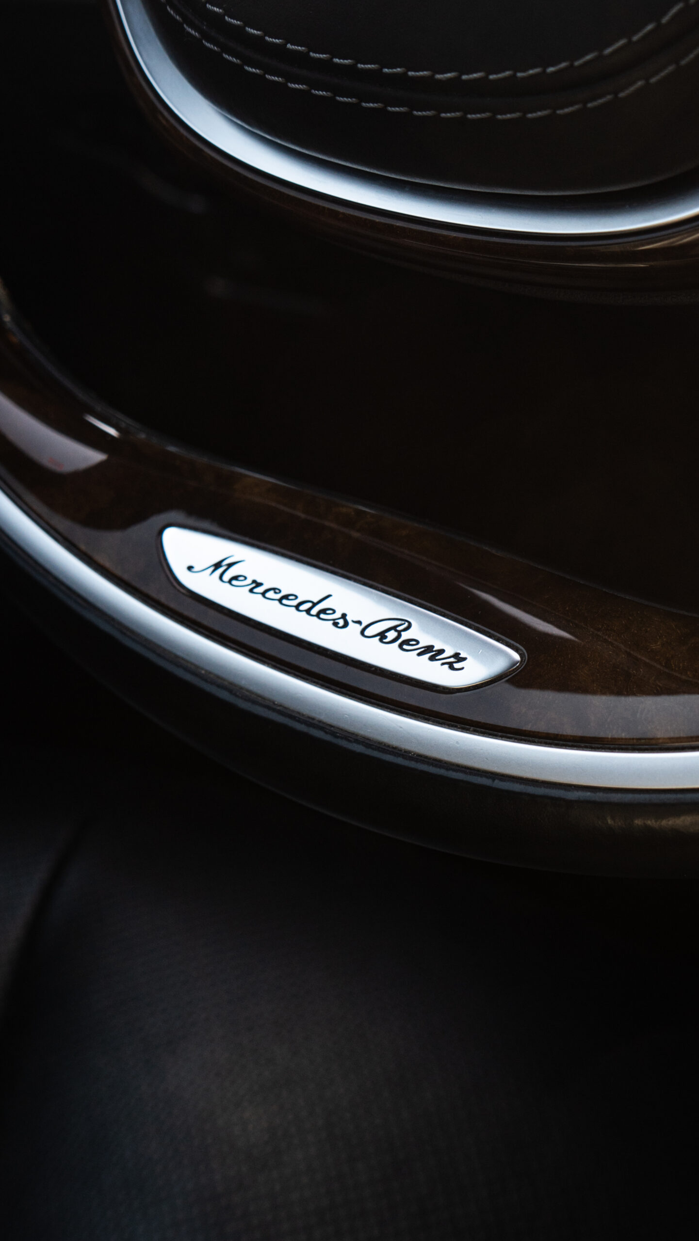 Interior detail of a Mercedes-Benz S-Class featuring the wood and leather steering wheel for private chauffeur services in Haro, Rioja.