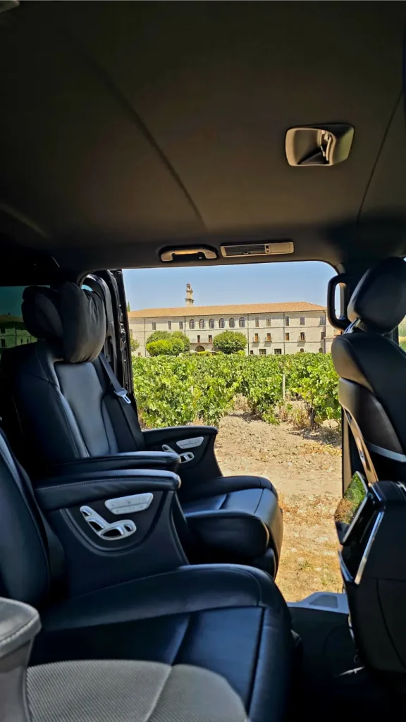 Mercedes V-Class vehicles from the luxury taxi fleet waiting for customers in front of the historic Abadía Retuerta winery on the Golden Mile.